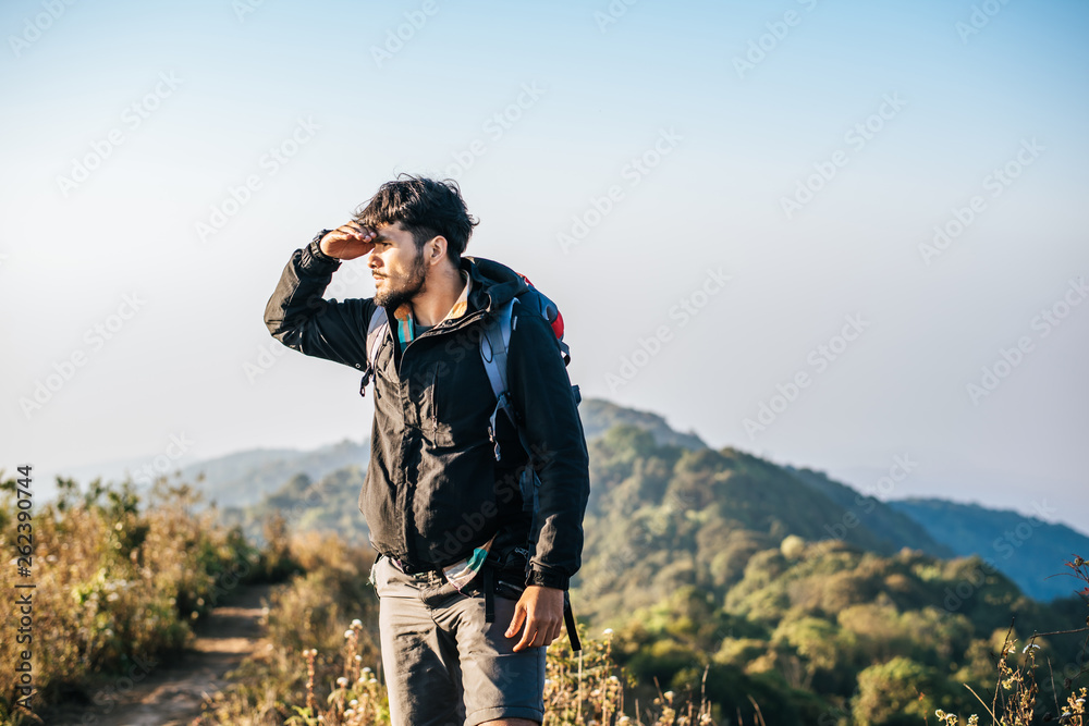 Man traveling with backpack hiking in mountains