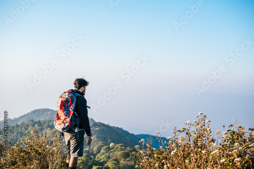 Man traveling with backpack hiking in mountains