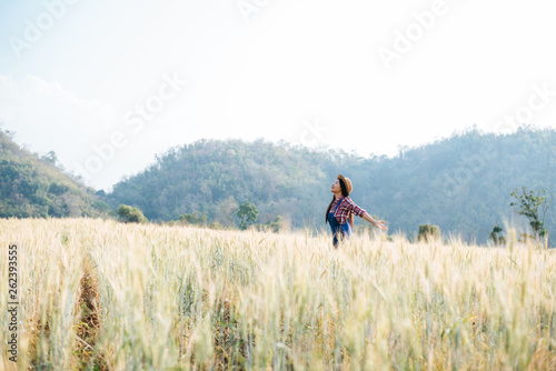 Woman farmer with barley field harvesting season © Johnstocker