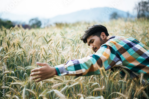 Handsome man farmer with barlay field photo