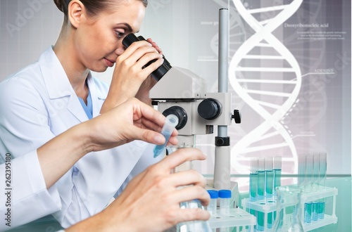 Female Scientist Working with Microscope in Laboratory