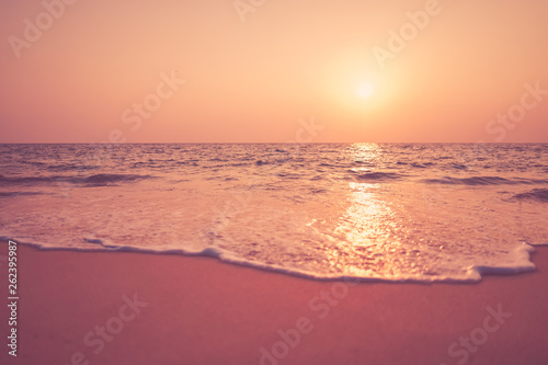 Tropical beach with sunset sky and cloud background.