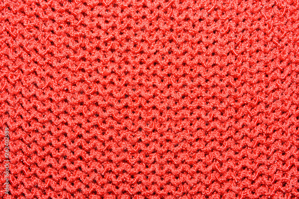 The texture of the knitted red fabric for the background The texture of the knitted red fabric for the background