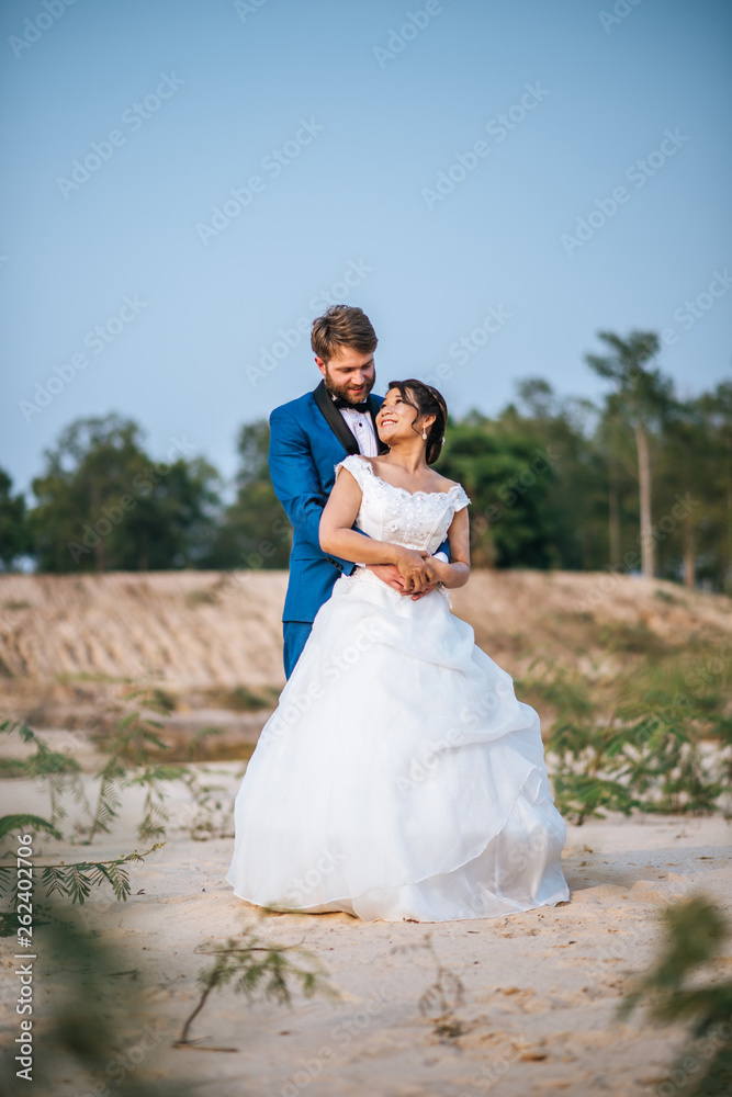 Asian bride and Caucasian groom have romance time and happy together Asian bride and Caucasian groom have romance time and happy together