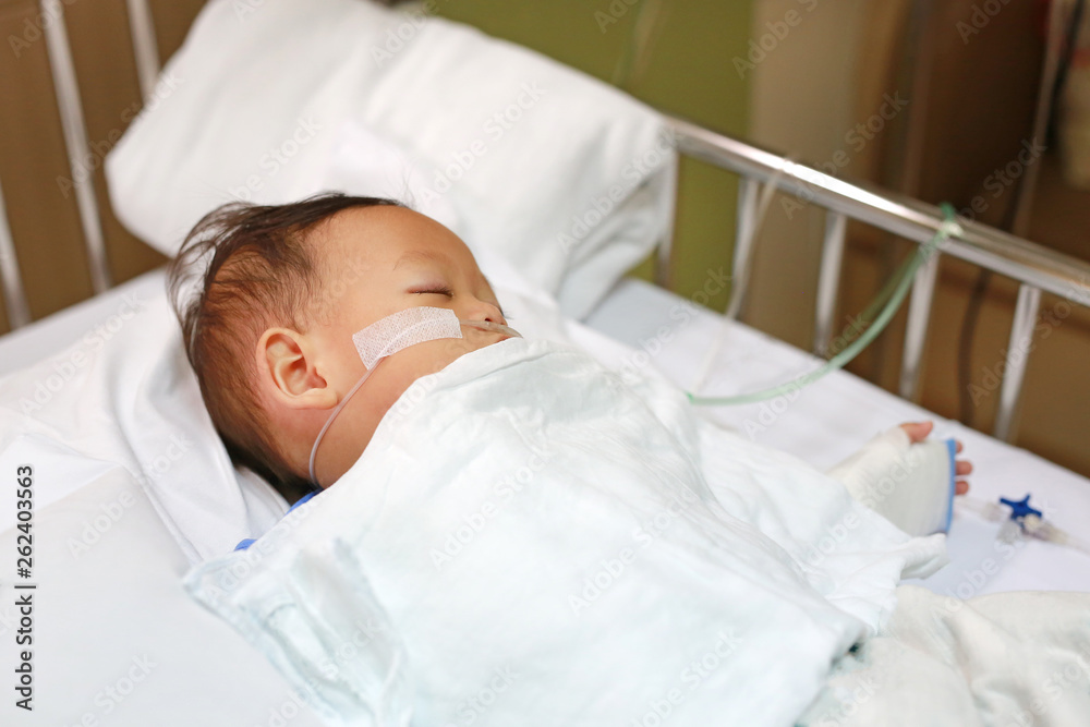 Baby boy with breathing tube in nose receiving medical treatment