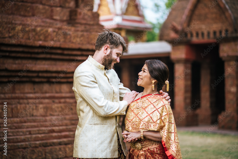 Asian bride and Caucasian groom have romantic time with Thailand dress Asian bride and Caucasian groom have romantic time with Thailand dress