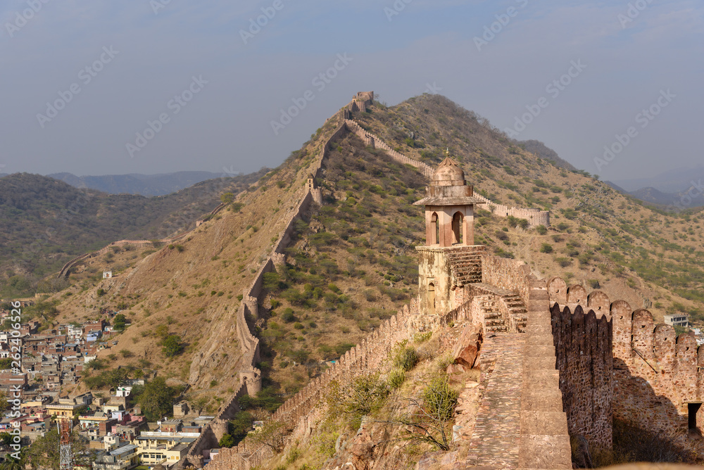 Ancient long wall with towers around Amber Fort and view of Amber village. Rajasthan. India