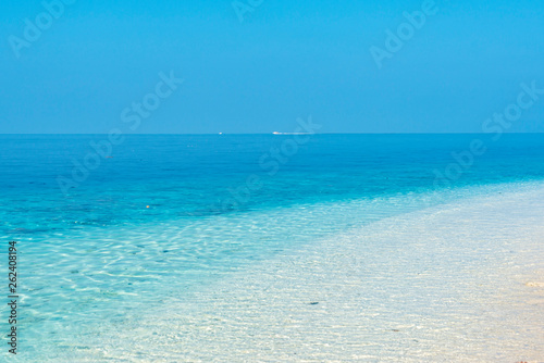 View on the blue ocean from a white sand beach