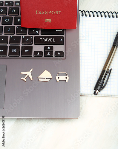 travel and wanderlust concept, planning summer vacation background. flat lay, space for text. Passport, notepad, laptop on white wooden table. top view.