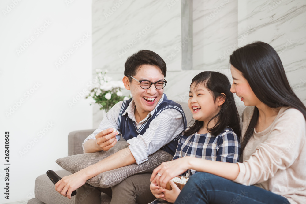 Happy Asian family lifestyle enjoy watching TV at home
