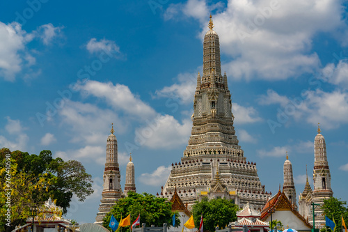 Wat Arun Ratchawararam with beautiful blue sky and white clouds. Wat Arun buddhist temple is the landmark in Bangkok, Thailand. Attraction art and ancient architecture in Bangkok, Thailand.