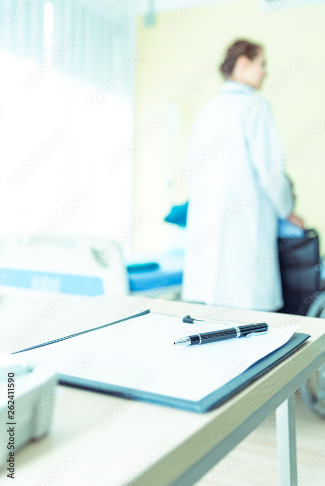 Blank medical clipboard healthcare with doctor and patient for blurred background.