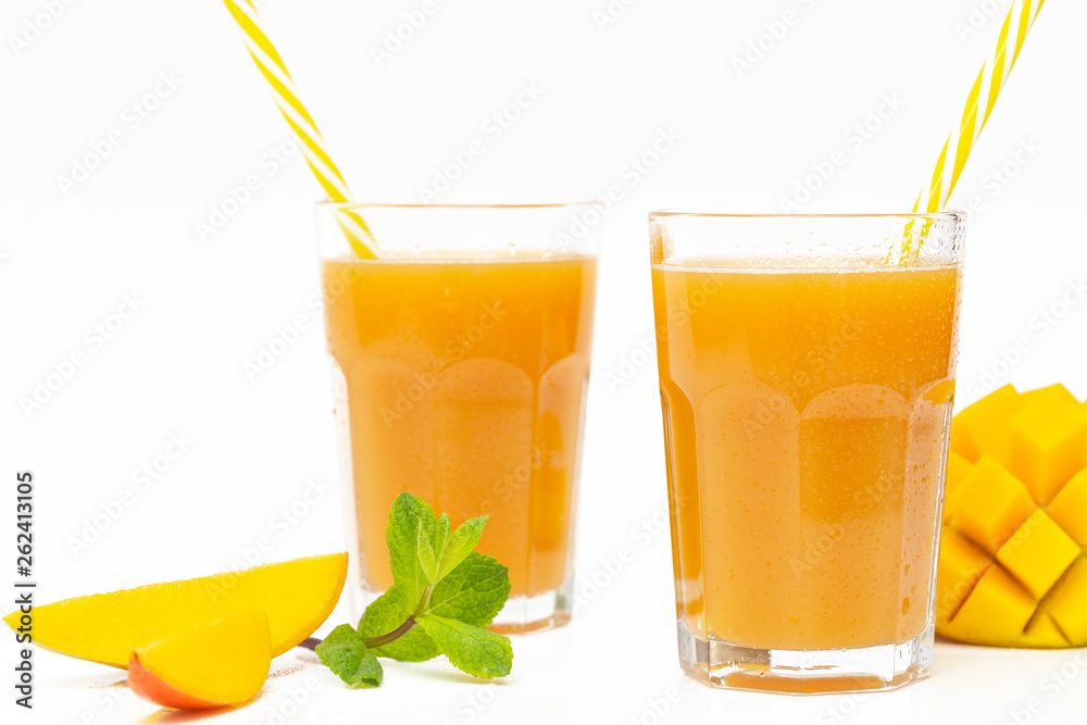 Fresh tropical fruit smoothie mango juice and fresh mango on a white background. Copy space.