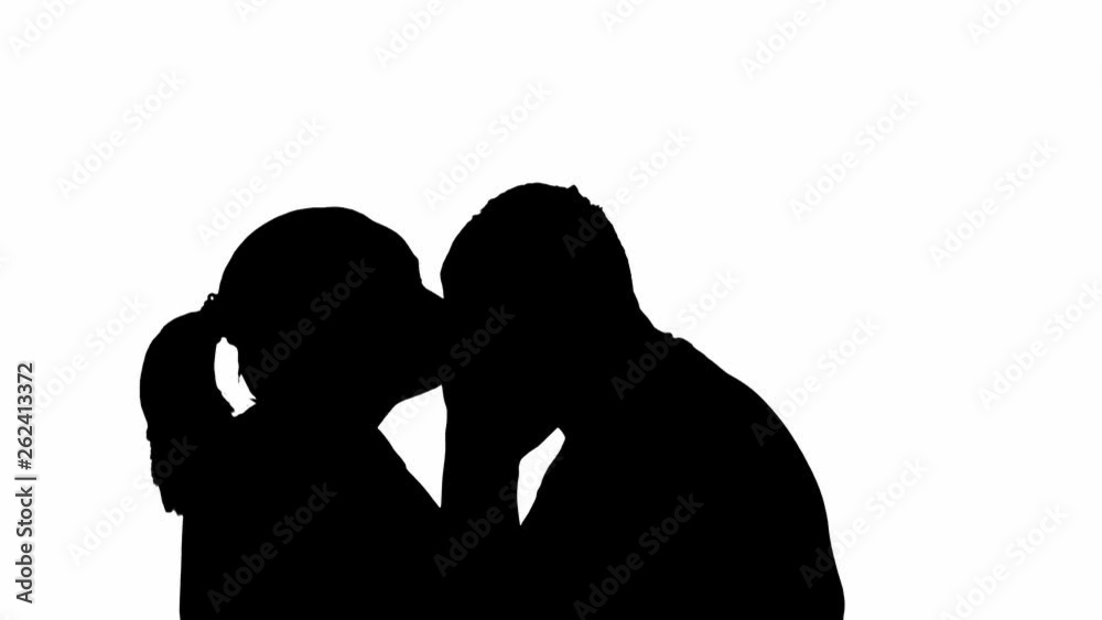 Silhouette couple man and woman kiss on a white background. Kiss between loving spouses. Silhouette couple man and woman kiss on a white background. Kiss between loving spouses.