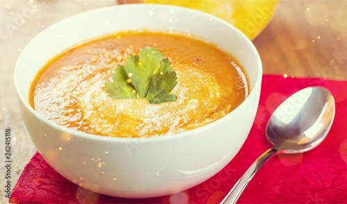 Tasty Pumpkin or  carrot soup on background