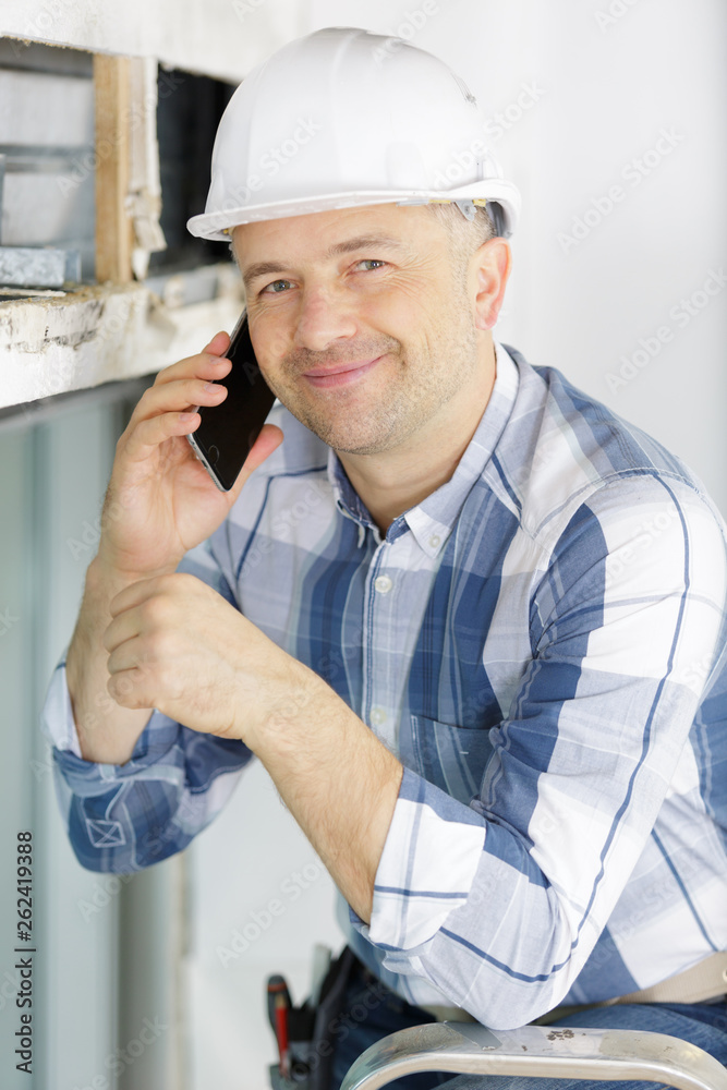 smiling foreman talking on cell phone smiling foreman talking on cell phone