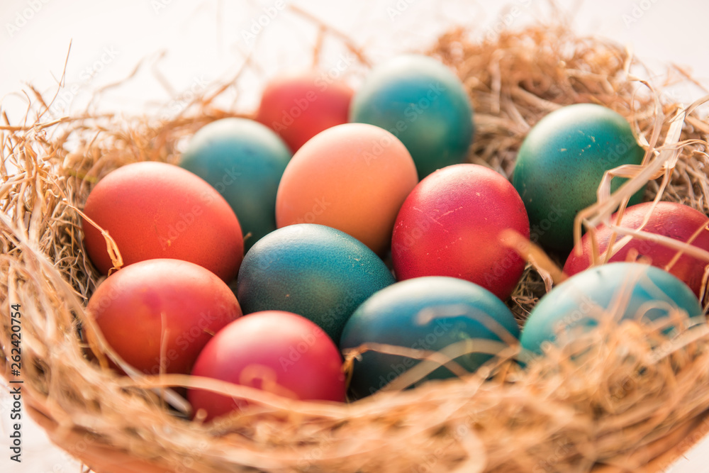 easter colorful eggs in a basket spring concept on a white background with room for text easter colorful eggs in a basket spring concept on a white background with room for text