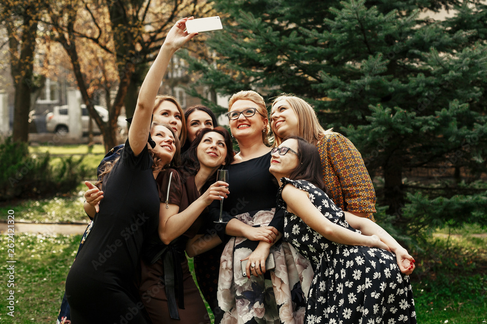 Fototapeta premium stylish elegant women taking funny selfie at celebration sunny in park, luxury happy life concept