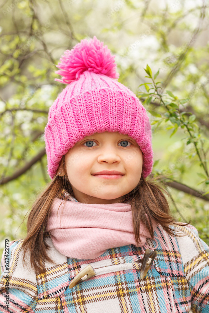 Portrait of a little girl in a pink hat in the spring. Portrait of a little girl in a pink hat in the spring.