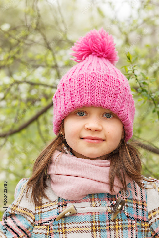 Portrait of a little girl in a pink hat in the spring. Portrait of a little girl in a pink hat in the spring.