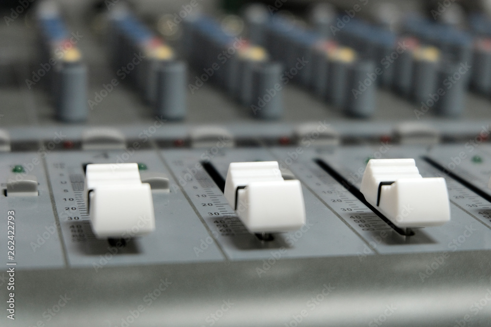 Mixing console close-up. Sound check for the concert. Mixer control. Music equipment and technology concept. Mixing console close-up. Sound check for the concert. Mixer control. Music equipment and technology concept.