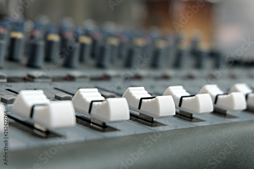 Mixing console close-up. Sound check for the concert. Mixer control. Music equipment and technology concept.