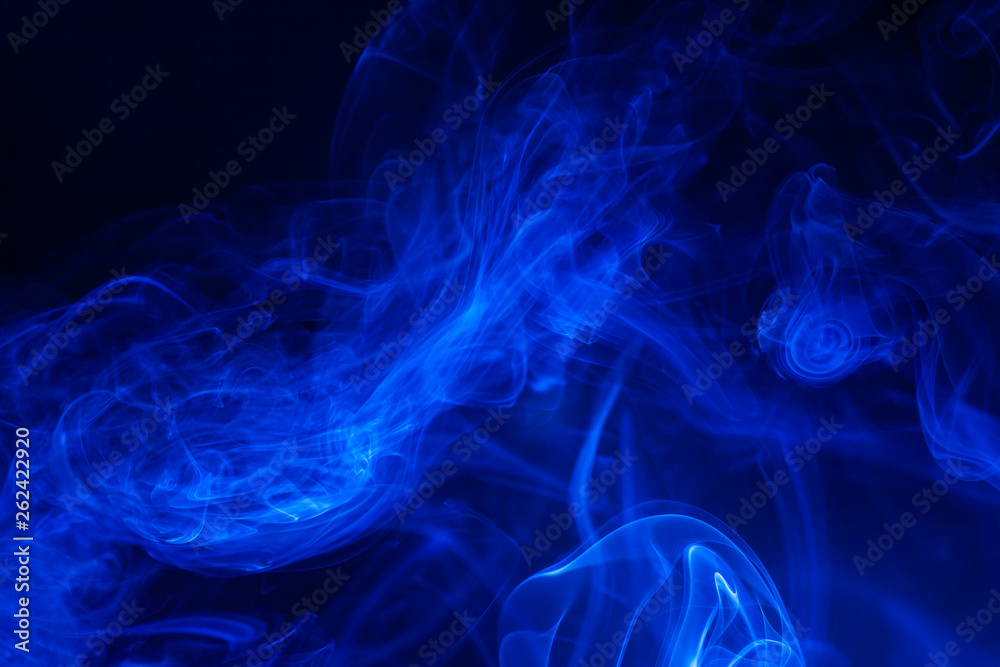 Blue smoke on black background.