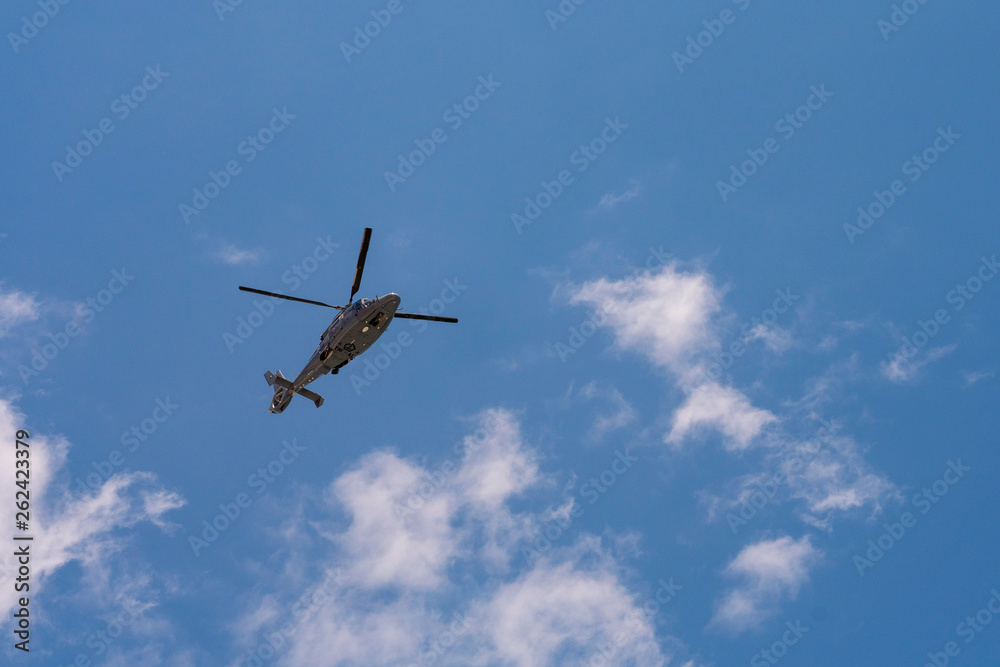 Helicopter flying in the blue sky