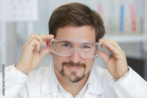 man wearing safety goggles in modern laboratory