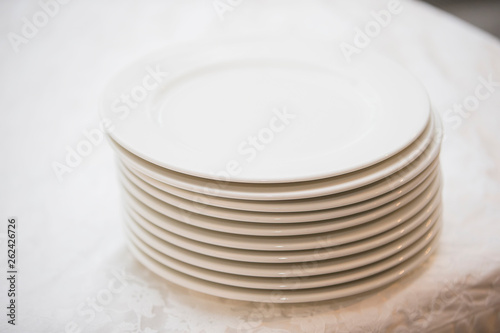 A stack of white plates on the table