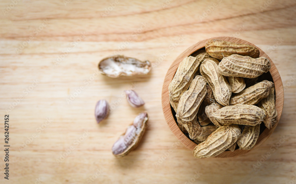 Peanut in wooden bowl and wood background top view / Boiled peanuts Peanut in wooden bowl and wood background top view / Boiled peanuts