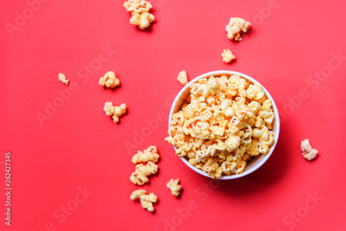 Popcorn in bucket on red background / Sweet butter popcorn salt