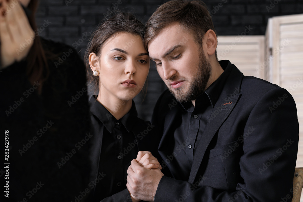 Couple pining after their relative at funeral Couple pining after their relative at funeral