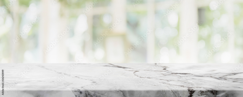 Empty white marble stone table top on blurred with bokeh shopping mall and restaurent interior banner background - can be used for display or montage your products