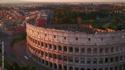 colosseum aerial view at sunrise fly orbit rome skyline italy photo