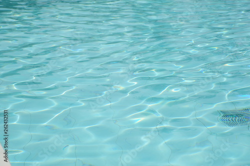 ippled Water abstract background, close up. Outdoor swimming pool in sunlight. Beautiful clear blue water background