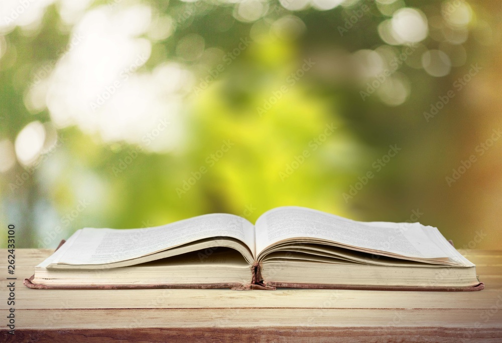 Open book on old wooden table Open book on old wooden table