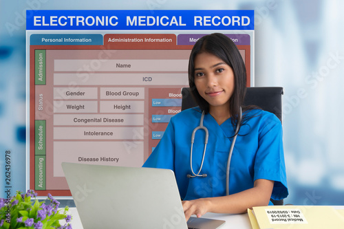 Female doctor with patient blank form of electronic medicale record system on background. photo