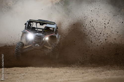 Offroad vehicle in the action on mud photo