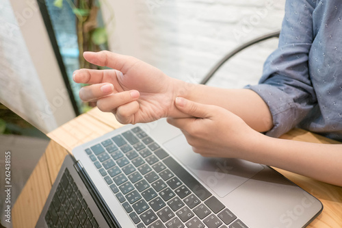 close up employee woman massage on his hand and arm for relief pain from hard working..working woman concept. photo