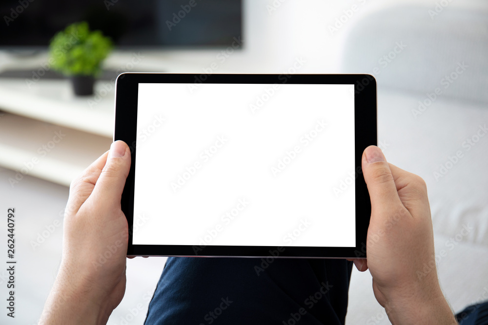 man hands holding computer tablet with isolated screen in room