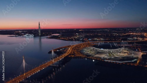 Saint-Petersburg, Russia. Aerial views to Gazprom Arena stadium as known as Zenit Arena and Krestovsky stadium illuminated Gazprom Arena in a spring evening. photo