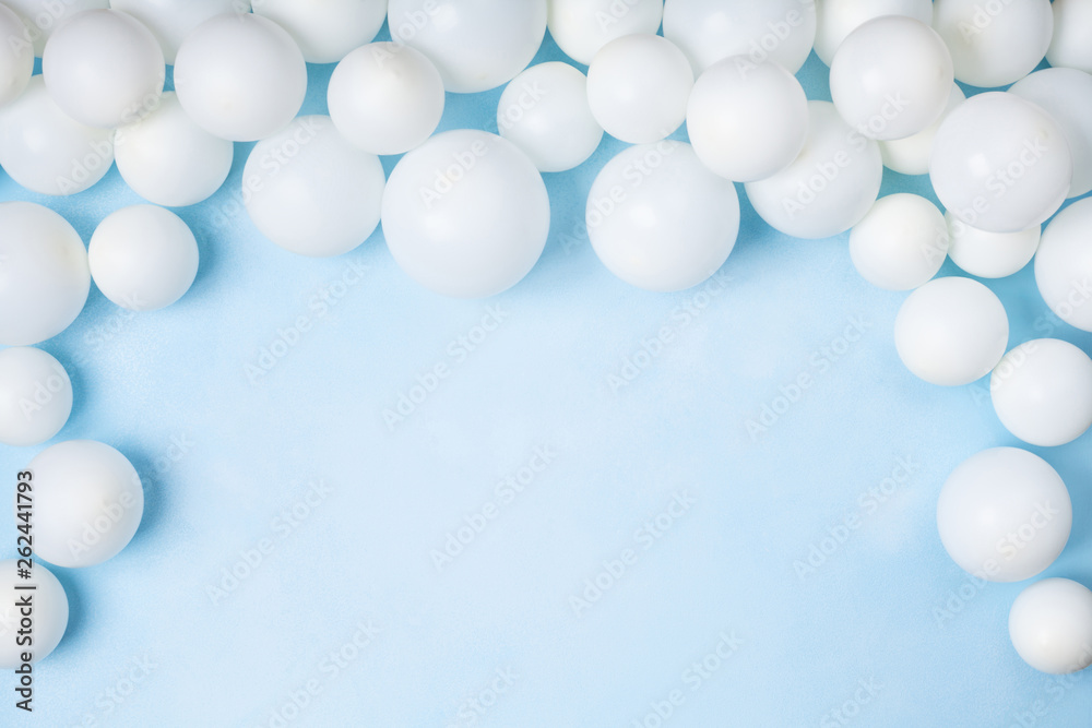 Pastel blue table with white balloons top view. Party or birthday background. Flat lay style. Pastel blue table with white balloons top view. Party or birthday background. Flat lay style.