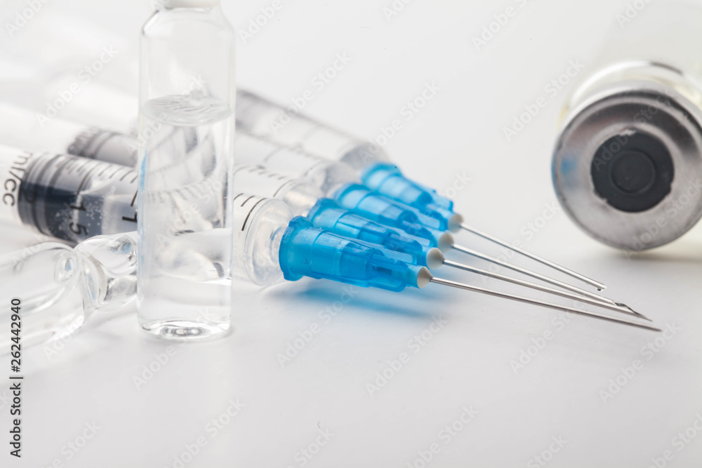 Subcutaneous syringe. Syringes with blue needles. Medical Injectors. Medical glass injection bottle. Ampoules with injections. Subcutaneous syringe. Syringes with blue needles. Medical Injectors. Medical glass injection bottle. Ampoules with injections.