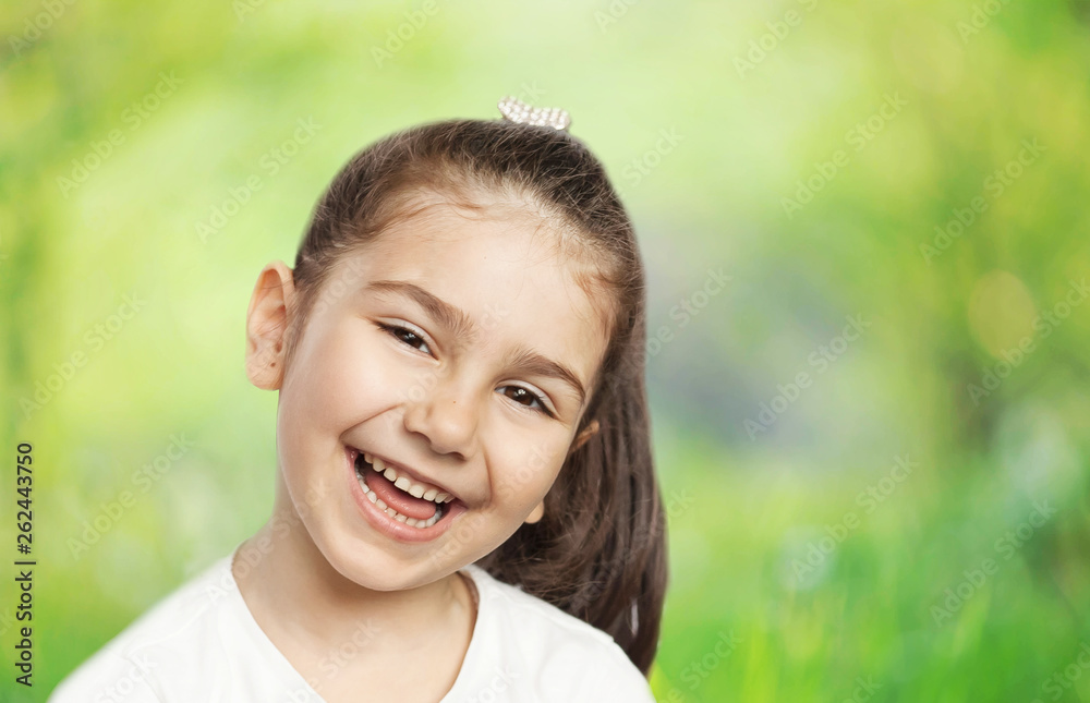 Happy cute child girl on the blur green background Happy cute child girl on the blur green background