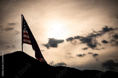 The concept, Labor Day: Flag of the United States against the sky and light of the sunset