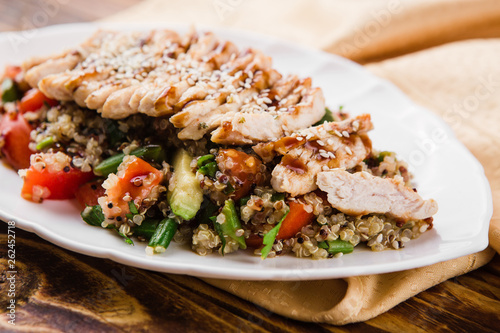 healthy salad with quinoa, vegetables and grilled chicken