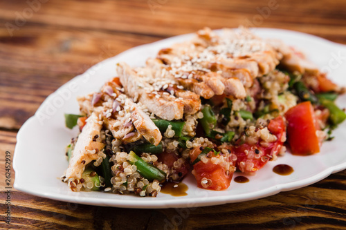 healthy salad with quinoa, vegetables and grilled chicken