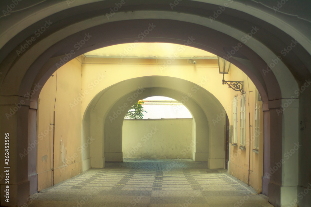 Mysterious courtyard in the rays of light in the old European city