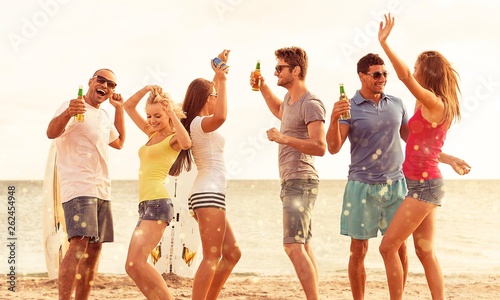 Group of young adults partying at the beach